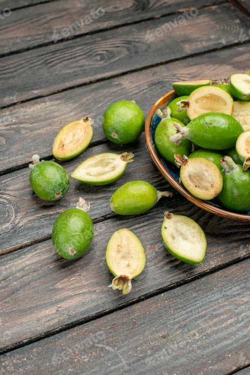 Preview: front view fresh green feijoas inside plate on the wooden rustic desk fruit color photo juice ripe