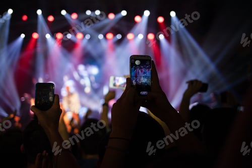 Preview: People at music concert hold smartphones up