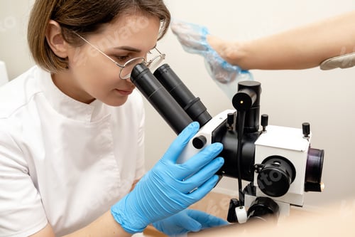 Preview: Gynecologist examines the patient on the gynecological chair using a colposcope.Women's Health.