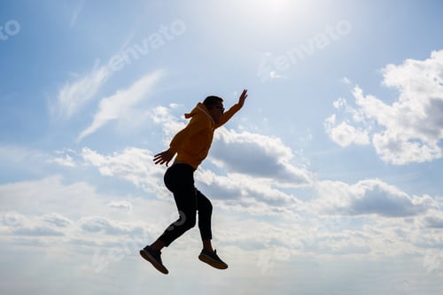 Preview: guy tourist freelancer on a background of blue sky with white clouds, bright sunny day