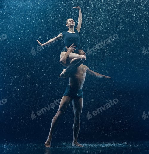Preview: Young couple of ballet dancers dancing unde rwater drops