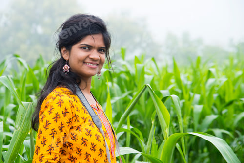Preview: Young girl in sorghum crop field, India.