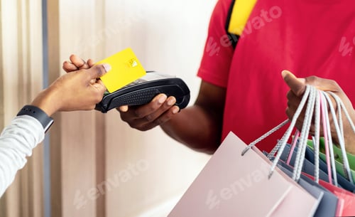 Preview: African Woman Making Payment With Credit Card For Delivery Indoors