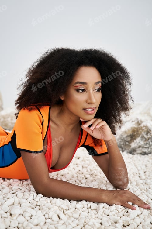 Preview: A beautiful young African American woman poses elegantly in stylish attire against a unique backdrop