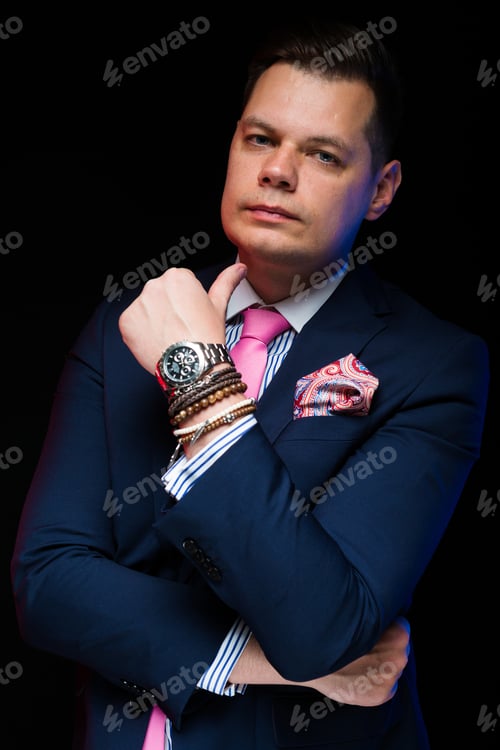 Preview: Portrait of confident handsome businessman with crossed arms with hand near his chin on black