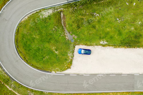 Preview: Top view on the blue car stands at the exit by the road near the Giau pass