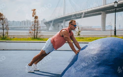 Preview: A professional athlete trains outdoors, does push-ups to get dressed, sportswear, sunglasses
