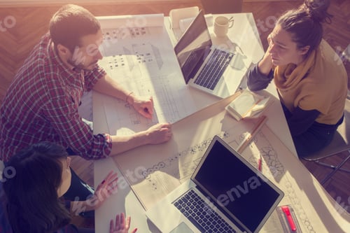 Preview: Young Group Of Architects Discussing Business Plans In A Natural Lit Office.