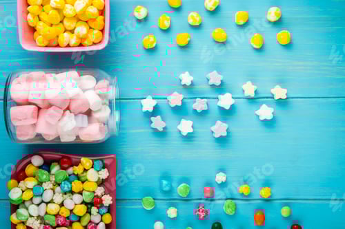 Preview: top view of bowls with various colorful candies and star shaped marshmallow