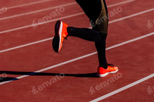 Preview: unrecognizable young athlete man running in the lanes. Daylight. Sports concept