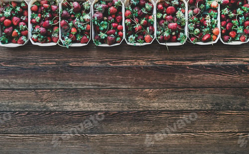 Preview: Fresh strawberries in plastic-free containers over wooden background, copy space