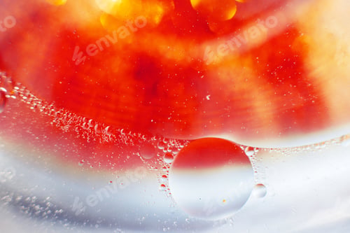 Vista previa: Oil bubbles close up. a circles of water macro. abstract blue and fiery red background