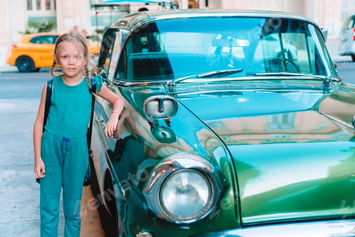 Preview: Tourist girl in popular area in Havana, Cuba. Young kid traveler smiling