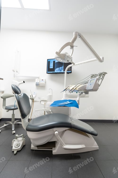 Preview: Modern dental practice. Dental chair, medical light, dental clinic without people. vertical photo