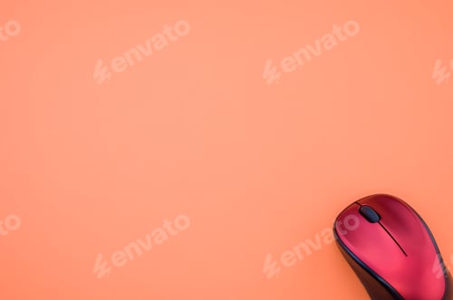 Preview: High angle shot of a wireless mouse on an orange surface
