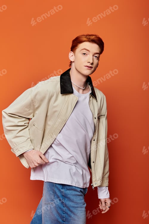 Preview: Emotional moment captured with a handsome young man on a vibrant orange backdrop