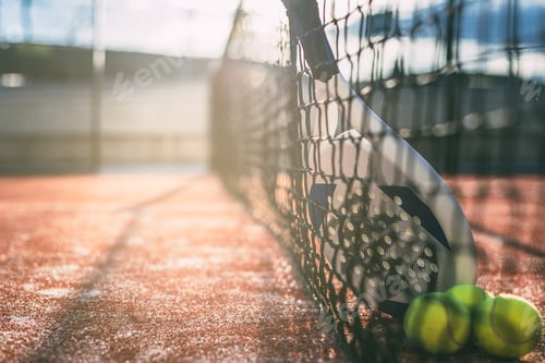 Preview: Padel blade racket resting on the net