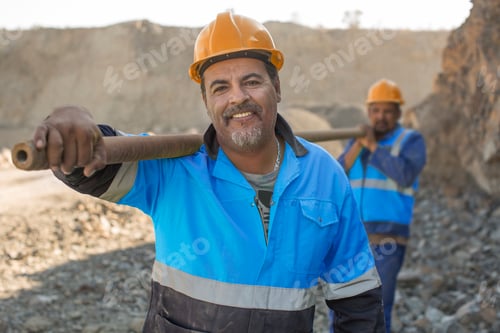 Preview: Construction workers holding tools at a worksite