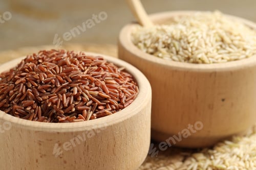 Preview: Different sorts of raw brown rice on table, closeup