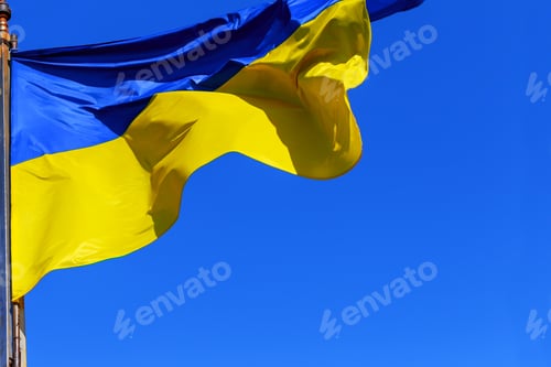 Preview: The national yellow and blue flag of Ukraine over the sky and clouds