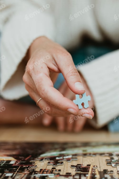 Preview: Woman putting together a jigsaw puzzle during self quarantine