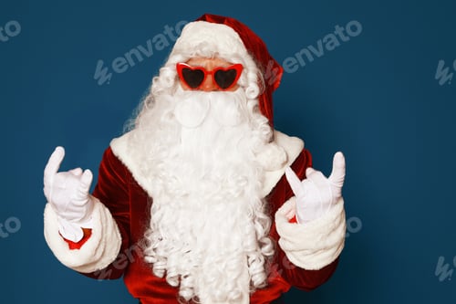 Preview: Authentic Santa Claus wearing sunglasses on blue background