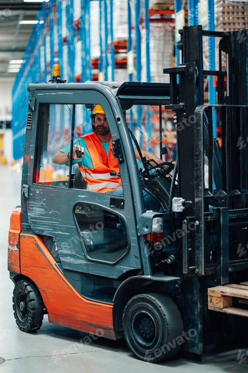 Preview: Warehouse worker driving forklift in logistics center
