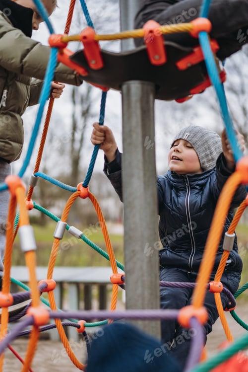Preview: Little boy climbing on playground