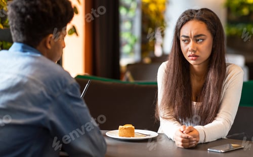 Preview: Young Girl and Guy Have Serious Conversation in Modern Cafe