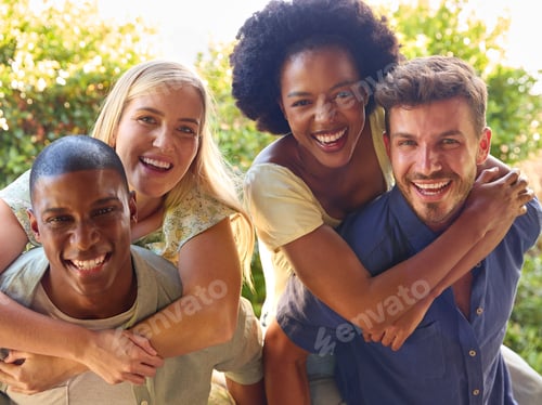Preview: Portrait Of Multi-Cultural Friends On Holiday With Men Giving Women Piggybacks