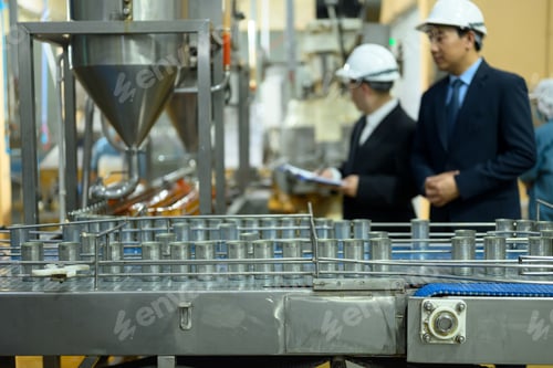 Preview: Industrial conveyor system transporting empty cans ready for filling at a seafood canning facility