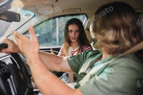 Preview: Young couple arguing inside a car, expressing frustration and emotions, natural light illuminating
