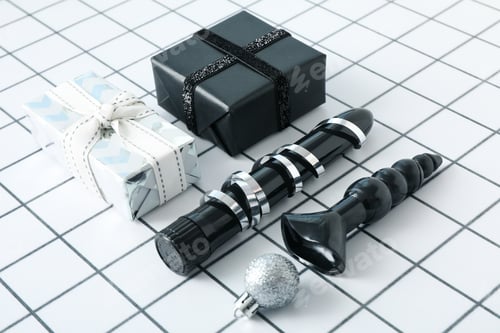 Preview: Sex toys with Christmas gifts on the background.