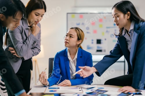 Preview: Team of asian businesspeople are discussing a project, analyzing financial documents with charts and