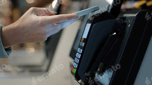 Preview: Details female hands paying with phone purchase by cell-phone electronic payment machine card reader