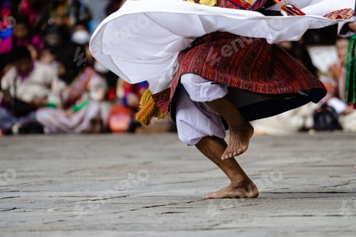 Preview: Traditional dancer in vibrant attire performing a cultural dance.