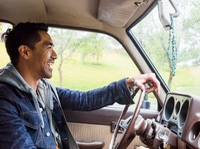 Preview: Young man in a car behind the steering wheel, driving.