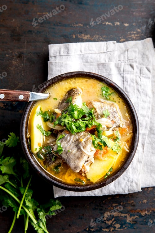 Preview: CHILEAN FOOD. Fish soup CALDILLO DE CONGRIO served in clay bowl, top view