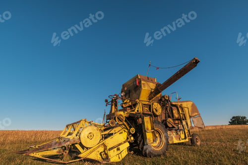 Preview: Closeup shot of harvester machinery on a clear blue sky background