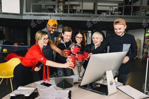 Preview: Group of international students or workers in loft office clinking cups of coffee, six colleagues of