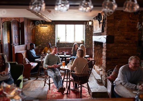 Preview: Couple Meeting For Lunchtime Drinks In Traditional English Pub