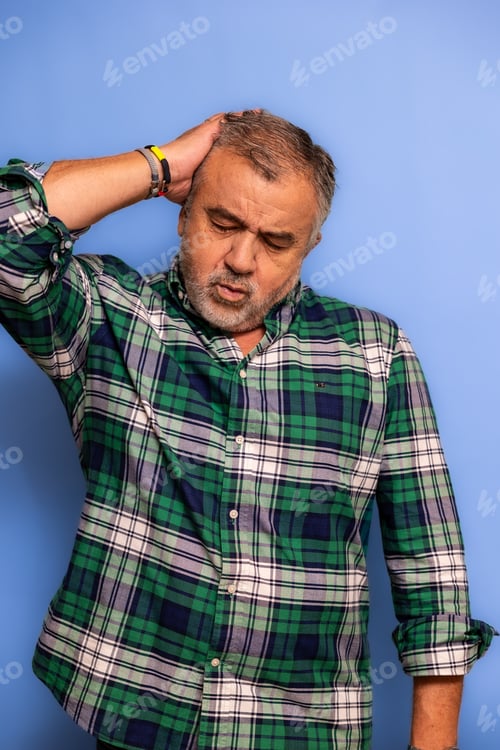 Preview: vertical Stressed middle aged man suffering headache hand on head