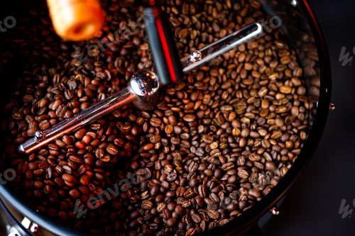 Preview: Coffee beans in a coffee machine, in dark colors.