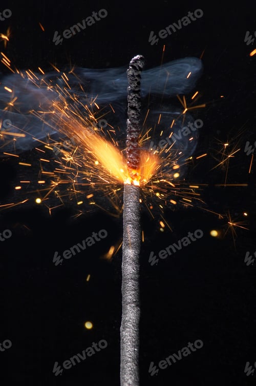 Preview: Close up burning sparkler isolated on black background