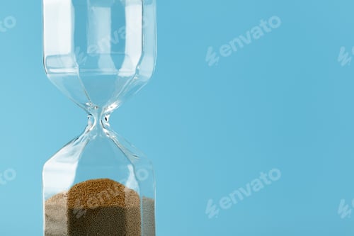 Preview: Close up of sandglass on paper background