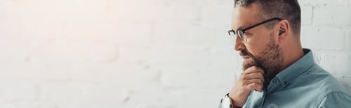 Preview: Contemplative Man with Beard in Home Setting