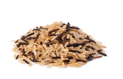 Preview: Pile of uncooked wild rice on white surface