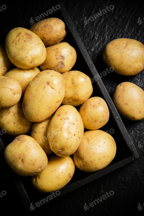 Preview: Fresh potatoes. On black background.