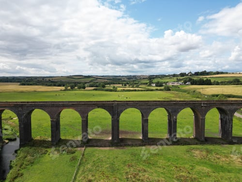 Preview: Aerial of the beautiful bridge in Viaduct in Southern England surrounded by green fields