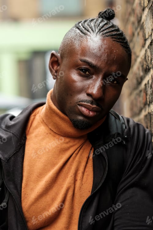 Preview: Expressive male model looking at camera in the rain.